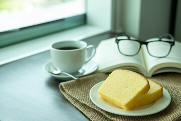 Snacks in the morning break. There are butter cakes, coffee on the table next to the window of the weekend