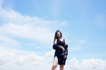 Asian woman long hair standing with blue sky for freedom and happy in the wind. Happiness of life is successful and travel in the world.