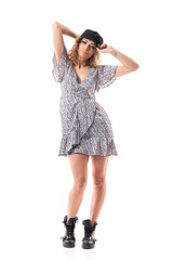 Cool trendy authentic look girl in summer flounce dress with untied boots posing and holding cap. Full body length isolated on white background.
