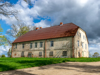 landscape with a beautiful stone building, Sunday school house near Trikata church, Latvia