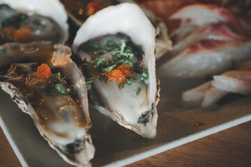 Fresh​ Oysters eat​ with​ sauce​ and​ topping​ with​ shrimp​ eggs in​ the​ Japanese restaurant