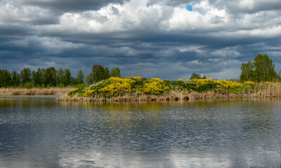 calm scene of beautiful sky with cumulus clouds reflection on the lake