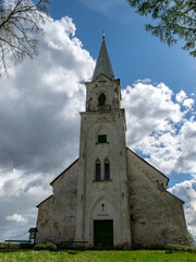 Fototapeta na wymiar white church on the hill, beautiful blue sky with white cumulus clouds, Trikata church, Latvia