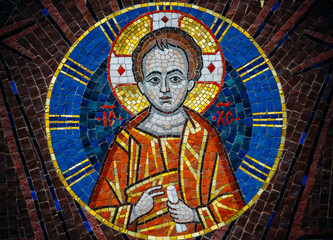 The Christian Virgin and Child Jesus in the form of ceramic mosaics on the facade of the Orthodox church. Traditional christian greek decor and fresco.