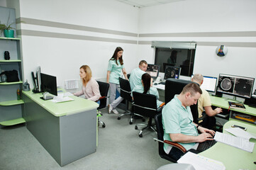 Fototapeta na wymiar Medical theme.Observation room with a computer tomograph. The group of doctors meeting in the mri office at diagnostic center in hospital.