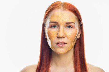 Beauty portrait of red head woman with gold mask on face. Skincare cleansing eco organic cosmetic