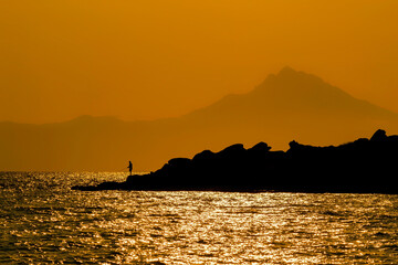 Athos Mountain, Greece. Sunrise landscape with fisherman.