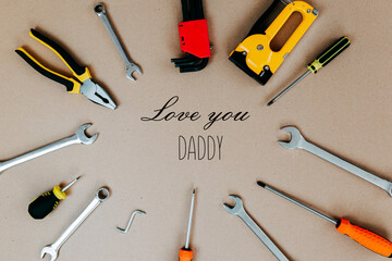 Tools top view on craft paper. Father's day card with tools. Plier, open wrenches, screwdrivers and staple gun in a cirlce.