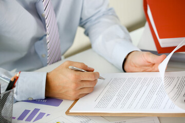 Hand of businessman in suit filling and