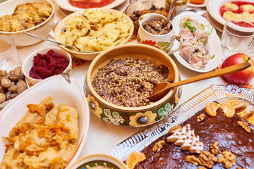 Traditional Ukrainian food. Kutya, borsch, dumplings, cabbage rolls on festive table.
