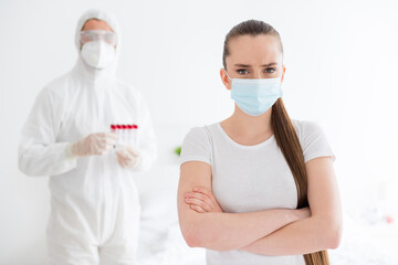 Photo of sick patient student lady arms crossed unwell call emergency doc virologist collected blood probe hold test tubes flu cold covid checkup wear mask protective uniform bedroom indoors