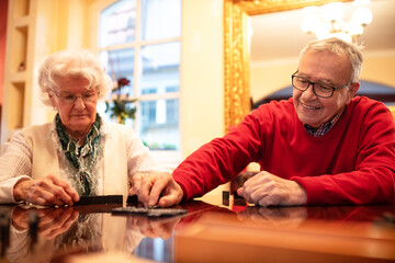 Older folks enjoying playing board games