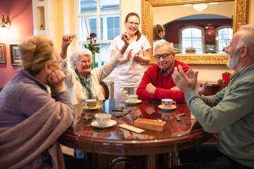 Senior woman celebrates a board game win
