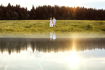 Fototapeta premium Loving couple in the river. Sunset.
