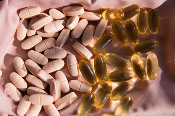 Vitamins and omega 3 fish oil on the natural background.