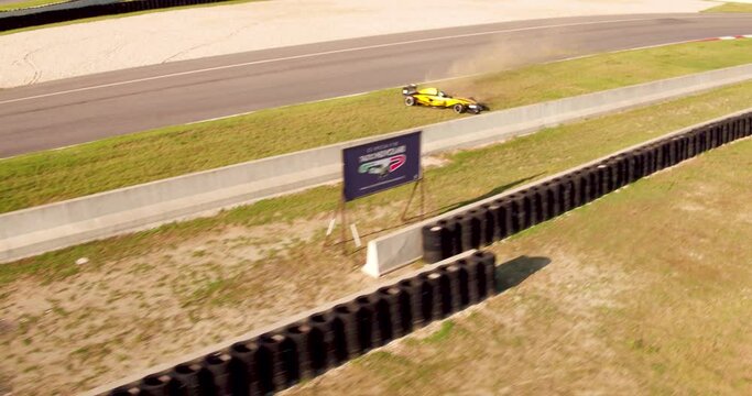 A Yellow Racing Car Drifting On The Roadside During A Car Race Event In Italy - tracking shot