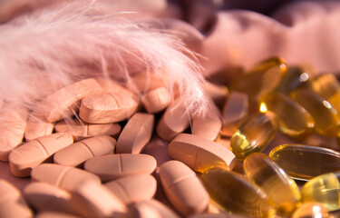 Vitamins and omega 3 fish oil on the natural background.