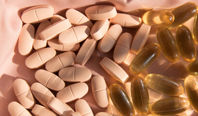 Vitamins and omega 3 fish oil on the natural background.