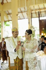 An Indonesian couple display their marriage certificates after wedding ceremony