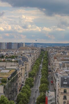 Beautiful, dark, calm photo of Paris avenues and boulevards taken at sunset from the Arc de Triomphe