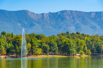 Landscape of Tirana viewed behind a fountain on an artificial lake, Albania
