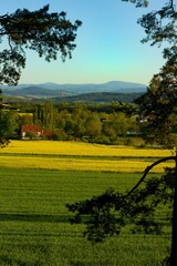 Obraz premium Typical panoramic preserved spring rural country landscape with small village of South Bohemia, Czech Republic