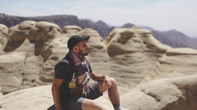 Adventurer enjoying the views, mountains background, peaceful atmosphere, nature reserve in Jordan, static shot
