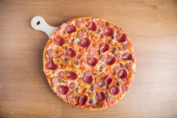 Mixed beef pizza on a wooden board