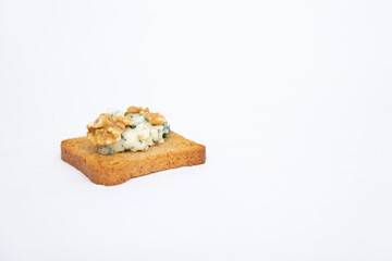 Snack of toasted bread with blue cheese and walnut. Healthy French breakfast antipasto. Cheese snack concept