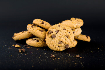 Chocolate chip cookie on black background