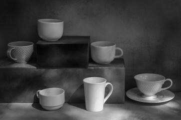 Art of coffee cups on shelves in light