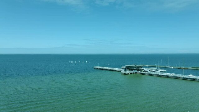 aerial view of the wooden pier over the sea, in the middle of the bridge wooden building, Zatoka Pucka Poland