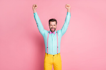 Portrait of his he nice attractive handsome glad successful cheerful cheery bearded guy wearing festal blue shirt rejoicing rising hands up holiday fest isolated over pink pastel color background