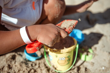 Sand castle and family at sea. Family beach vacation concept.