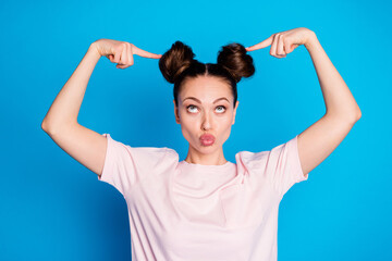 Photo of attractive lady two funny buns send air kisses direct fingers on head demonstrate new...