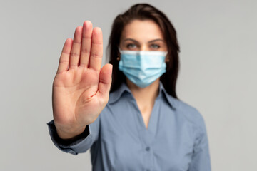 Woman in mask stopping coronavirus