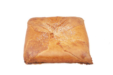 Square pie made of pastry with filling. Close-up on white background