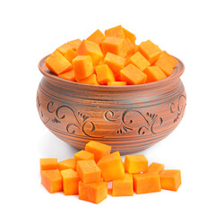 Ceramic tan pan filled with chopped pumpkin slices isolated on a white.