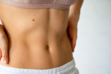 Fototapeta na wymiar beautiful athletic belly. inflated muscles of the female press.