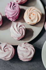 Colorful Air marshmallows on gray background. Fresh homemade sweet zephyr