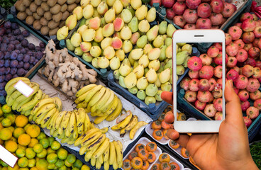 woman hand holding mobile phone pay market fruits, vegetables