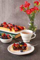 A wholemeal tart with chocolate filling  and fresh berry fruit