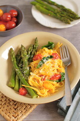 Spring pasta with cream sauce, spinach, tomatoes, asparagus and parmesan cheese