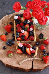 A wholemeal tart with chocolate filling  and fresh berry fruit