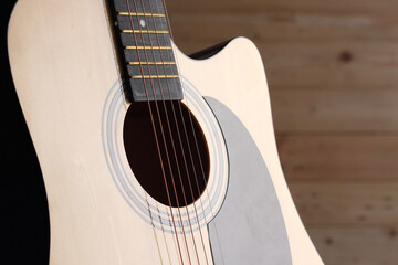 Fototapeta premium part of acoustic guitar on wood background 
