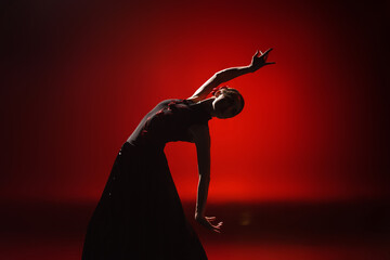 silhouette of young and attractive woman dancing flamenco on red - obrazy, fototapety, plakaty