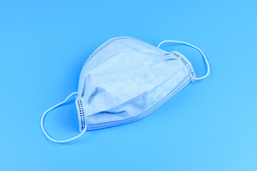 Protective face mask on a blue background. Healthcare and medicine concept