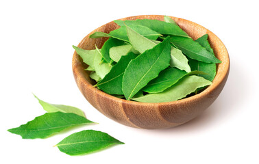 fresh curry leaves (Murraya koenigii) in the wooden bowl, isolated on white background