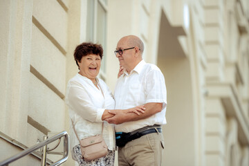 Handsome old man and attractive old woman are hugging