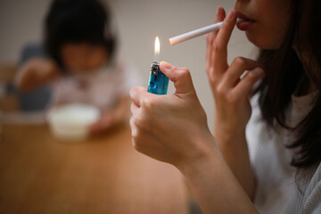 Obraz premium 子供の近くで喫煙する母親
